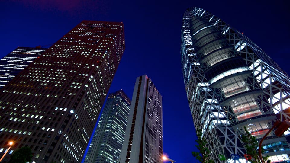 A cityscape at night with illuminated skyscrapers.