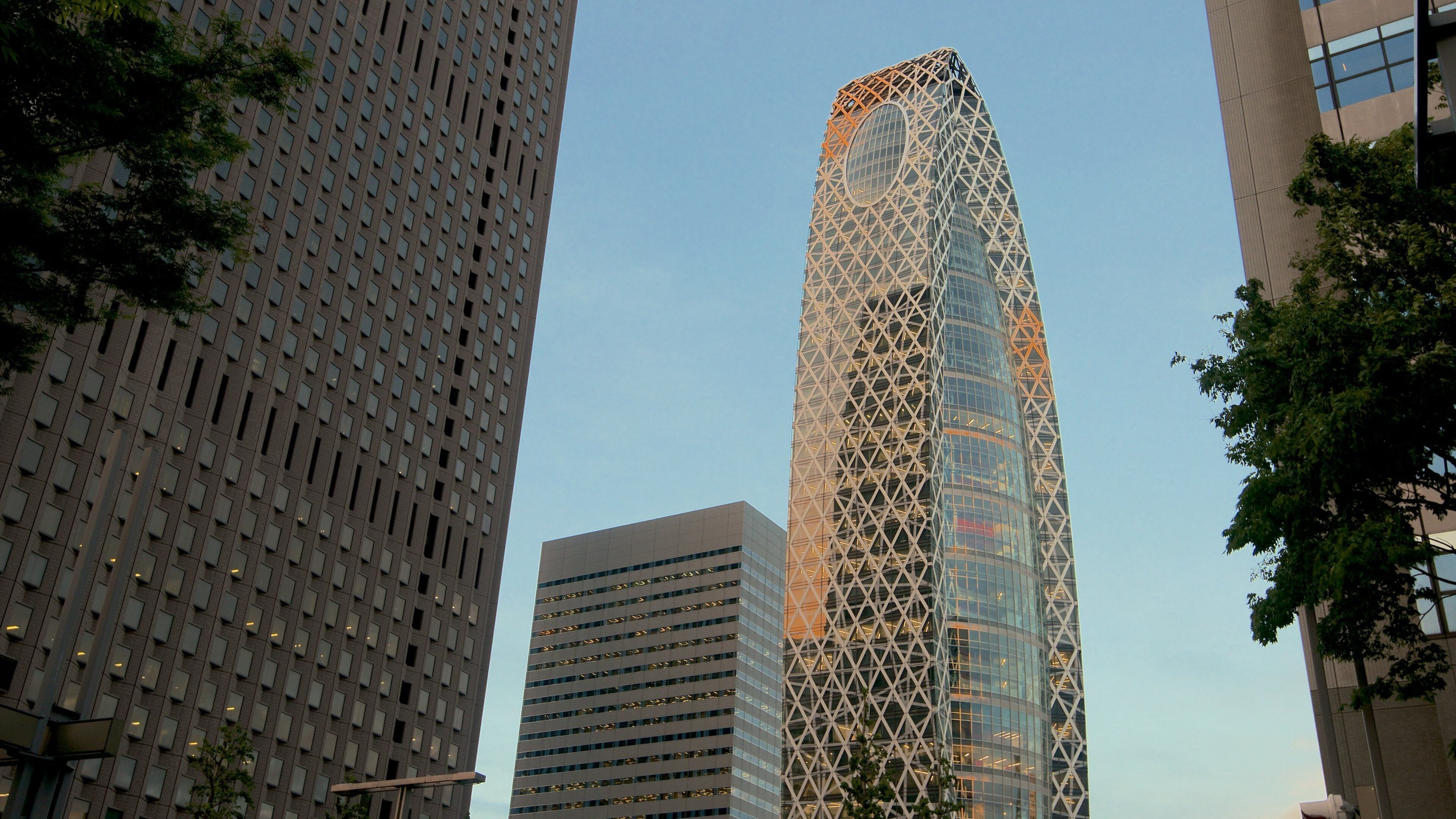 A modern cityscape with tall buildings, including a distinctive skyscraper with a geometric facade.