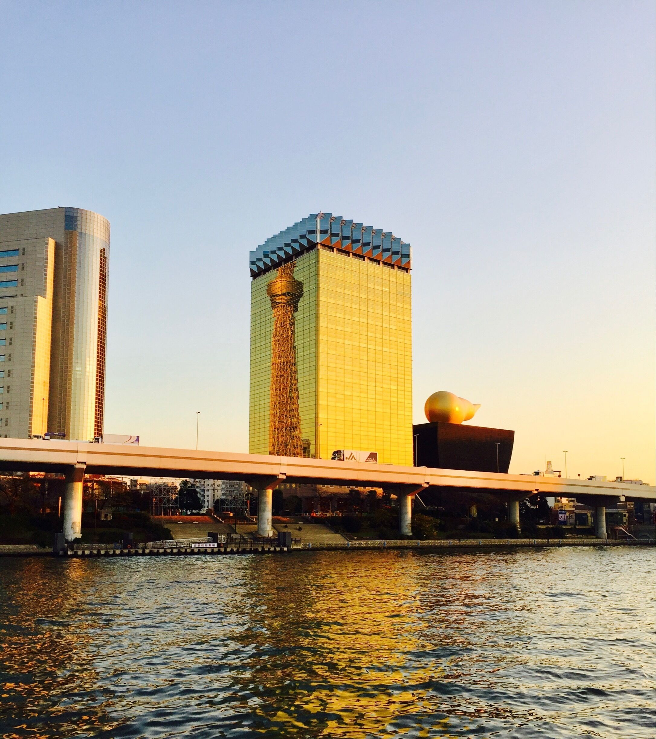 Tokyo Skytree reflected in Asahi's Headquarters on the Sumida River
