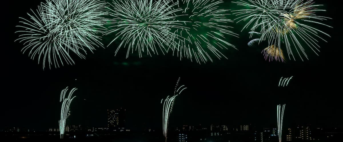 A night sky with multiple fireworks displays.