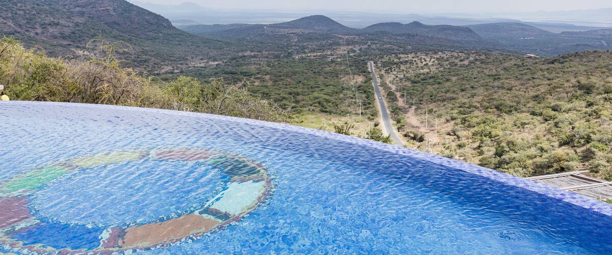 A swimming pool with a view of a mountainous landscape.
