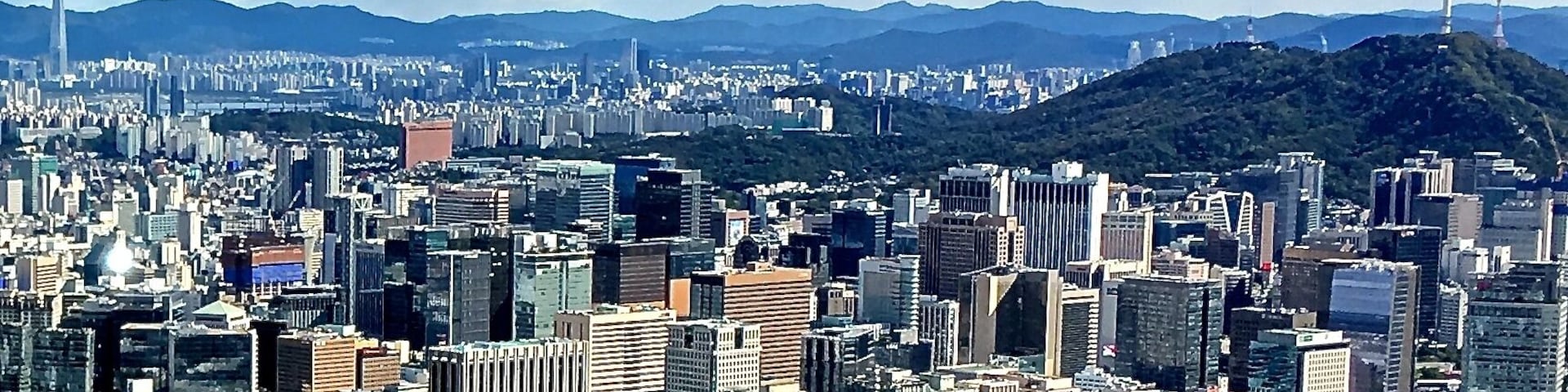 Comparison between Lotte World Tower and Namsan tower with skyline of Seoul. Photo taken from Inwangsan Hill.