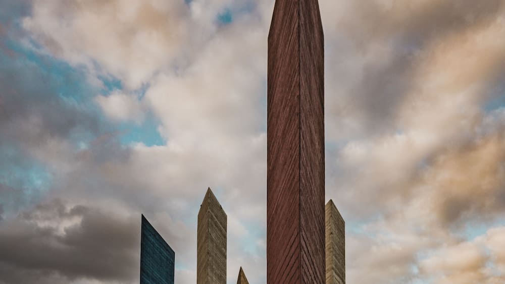 Torres de Satelite (Satellite Towers) monument landmark. Five iconic triangular towers along the highway traffic.