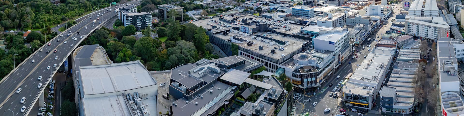 Aerial: Newmarket motorway overpass and retail stores, Auckland, New Zealand