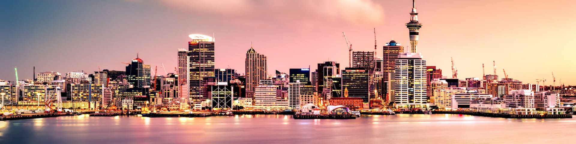Panoramic view of Auckland city skyline and harbour at sunset as seen from the North Shore. Auckland, known as the "City of Sails" is ethnically diverse and is the most populous city in NZ.