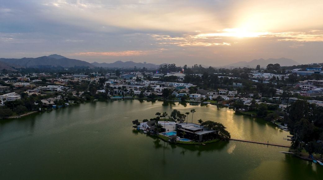 Lima, Perú - May 4 2019: Panoramic aerial view of Las Lagunas in La Planicie. Lake at sunset with houses of high class.