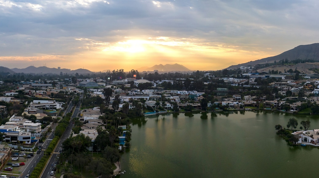Lima, Perú - May 4 2019: Panoramic aerial view of Las Lagunas in La Planicie. Lake at sunset with houses of high class.