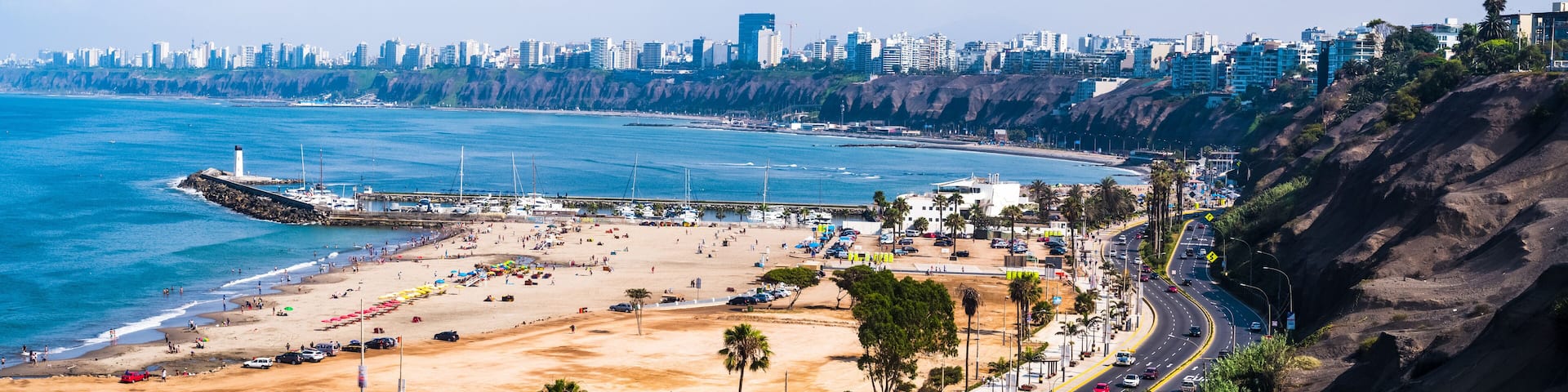 Panoramic aerial view of Sombrillas beach and the Costa Verde of Lima as background.