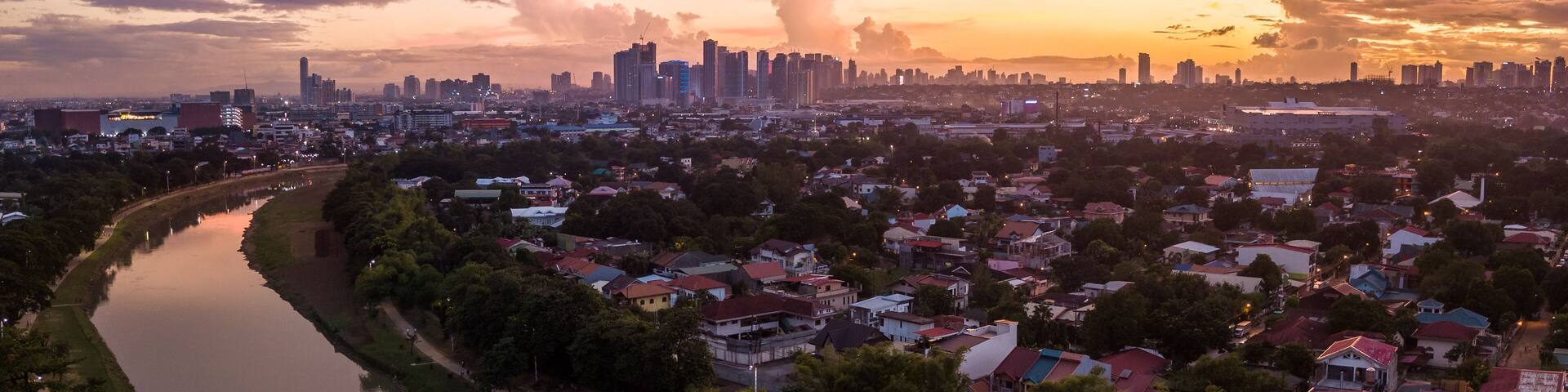 Scenic Drone Aerial Picture of the Marikina River and the Skyline of Eastwood City during Sunset in Metro Manila, Philippines