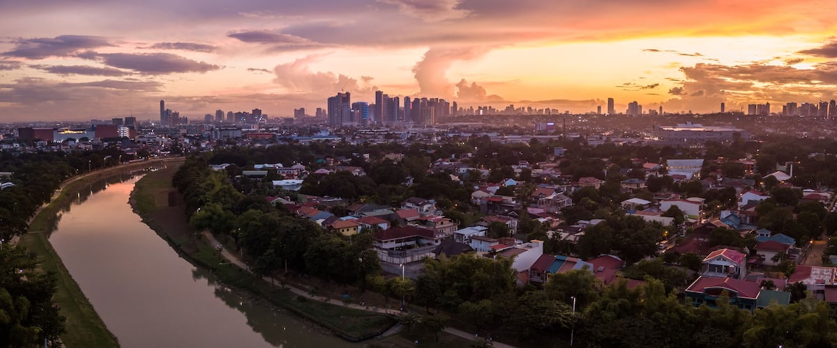 Scenic Drone Aerial Picture of the Marikina River and the Skyline of Eastwood City during Sunset in Metro Manila, Philippines