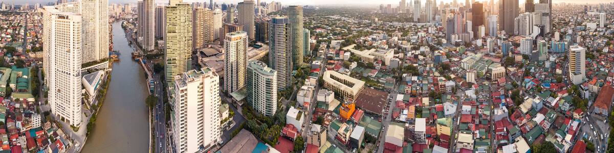 Makati, Metro Manila, Philippines - Afternoon Wide aerial panorama of Makati Skyline from the Pasig River. The clusters of Rockwell Center, Ayala CBD and the hotels and condos of Poblacion.