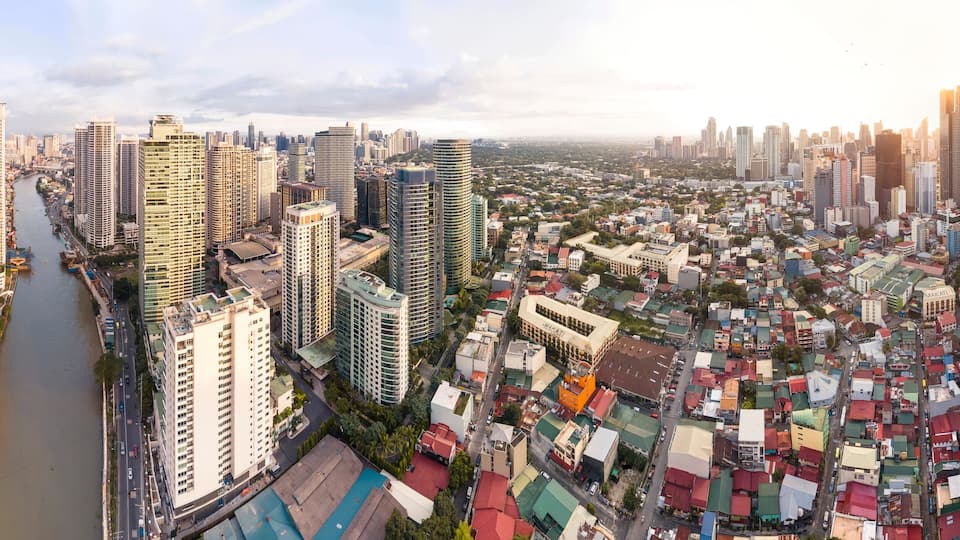 Makati, Metro Manila, Philippines - Afternoon Wide aerial panorama of Makati Skyline from the Pasig River. The clusters of Rockwell Center, Ayala CBD and the hotels and condos of Poblacion.