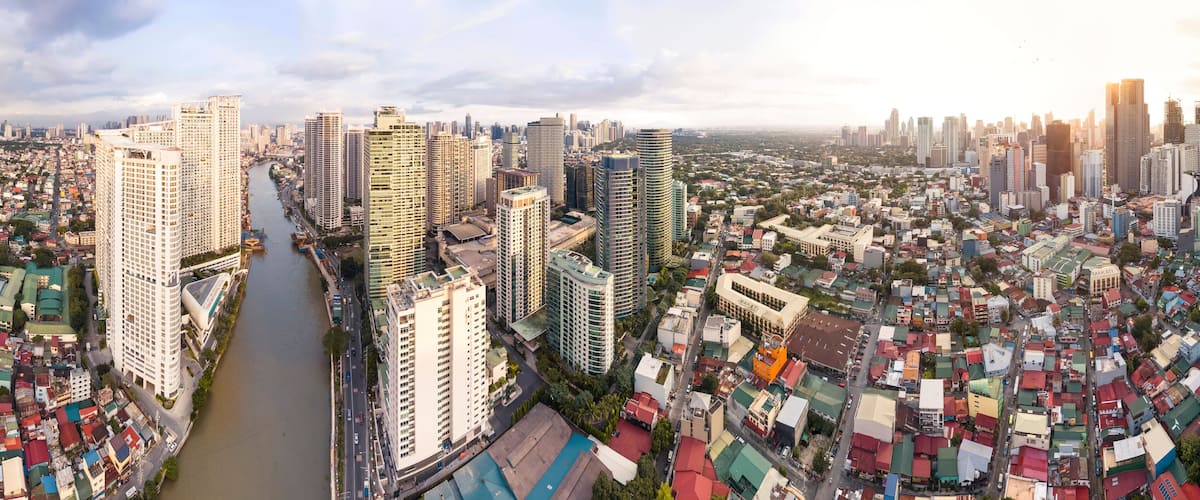 Makati, Metro Manila, Philippines - Afternoon Wide aerial panorama of Makati Skyline from the Pasig River. The clusters of Rockwell Center, Ayala CBD and the hotels and condos of Poblacion.