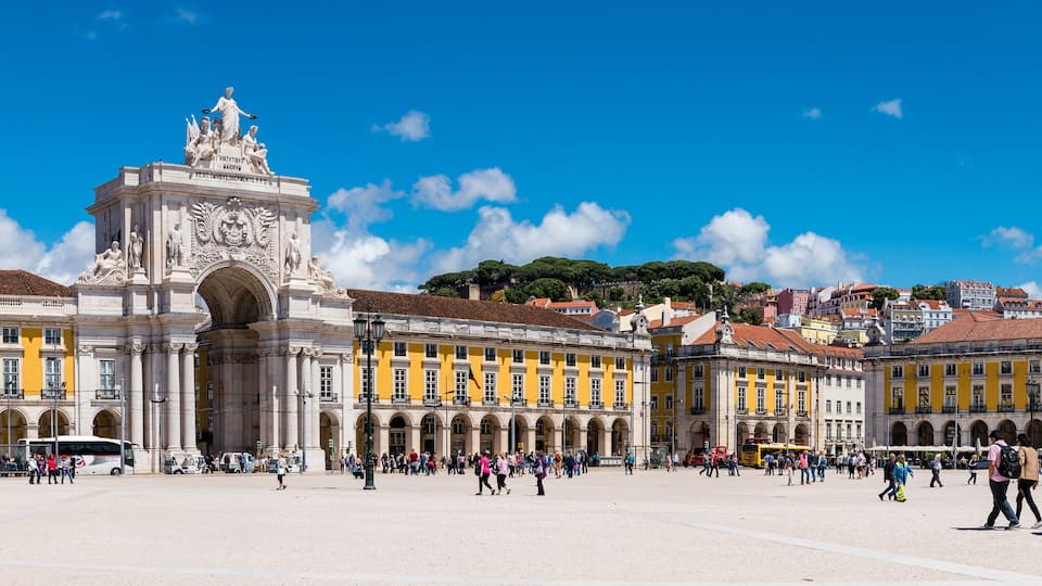 A historic square with ornate buildings and statues.