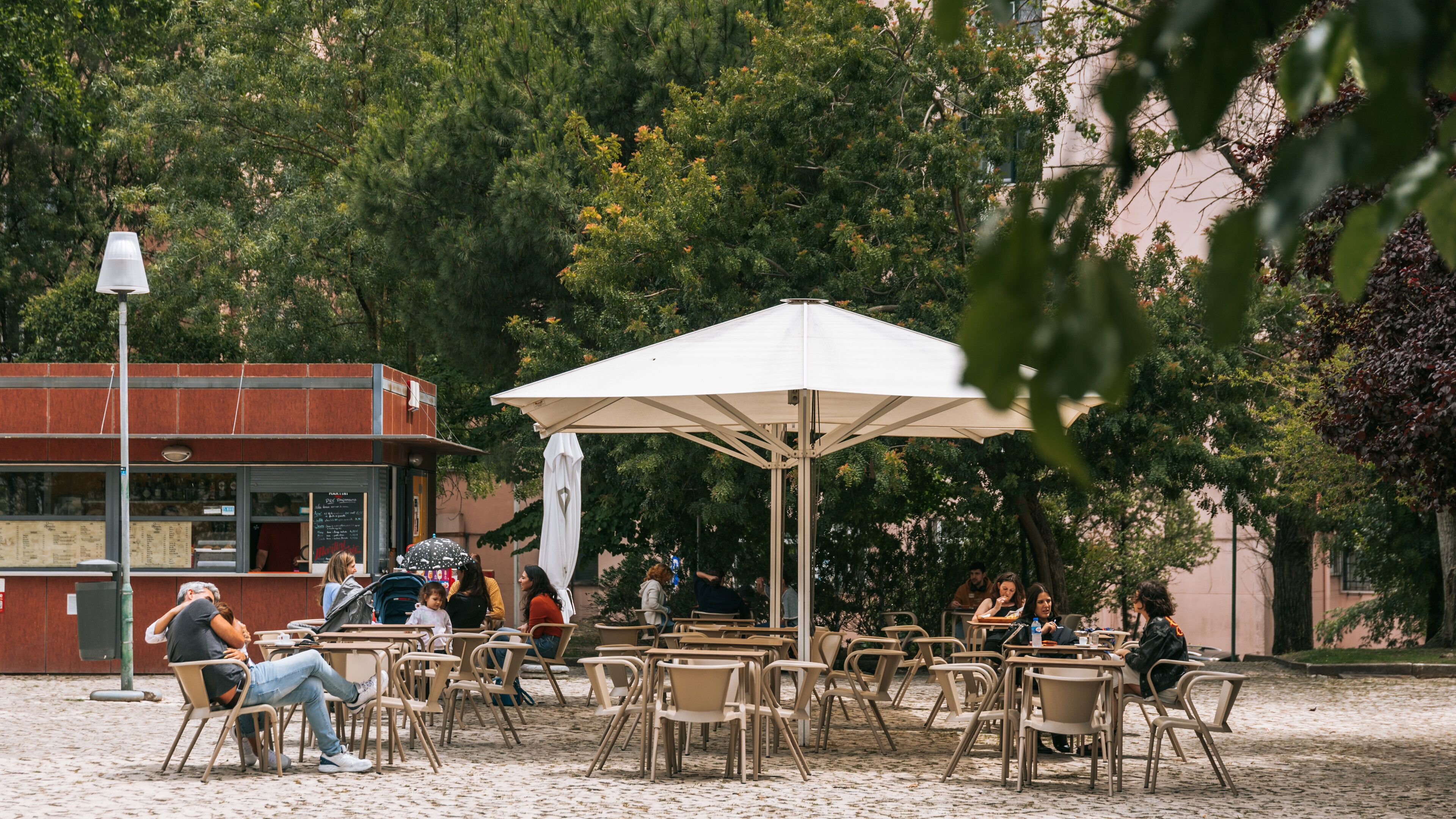 Areeiro which includes outdoor eating as well as a small group of people