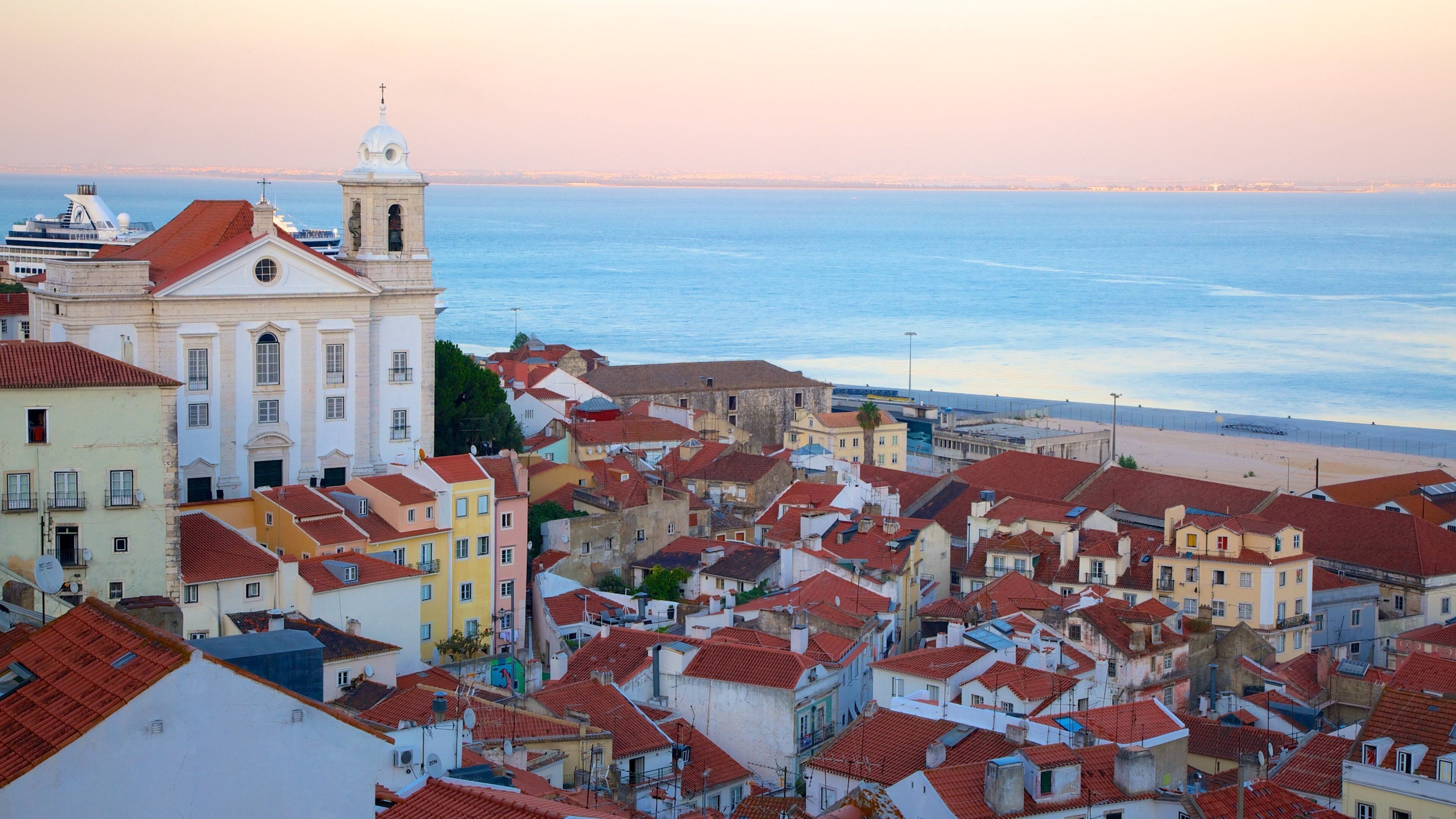 Alfama showing a sunset and a coastal town