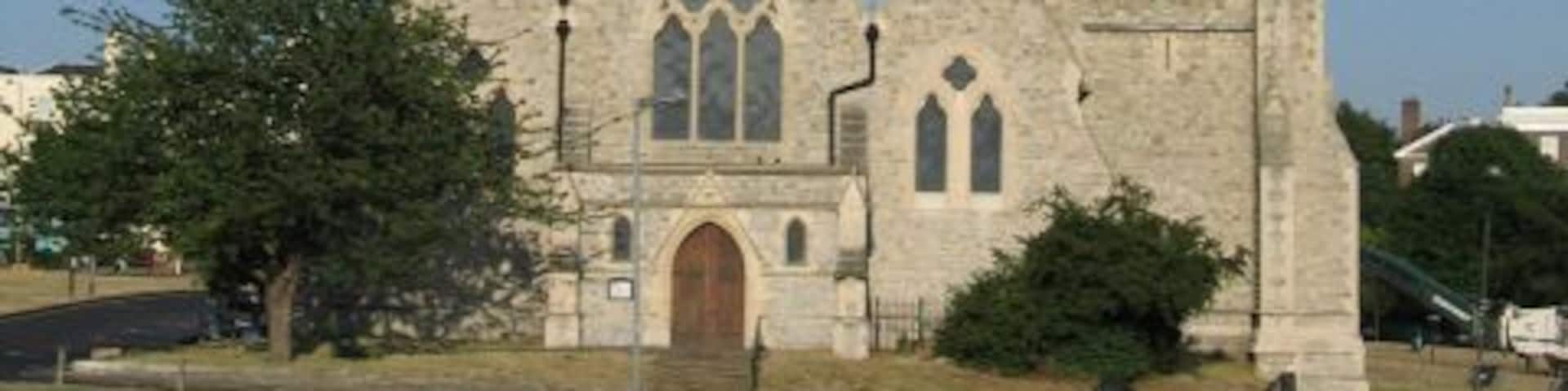 A church with a tall spire and a clock tower.