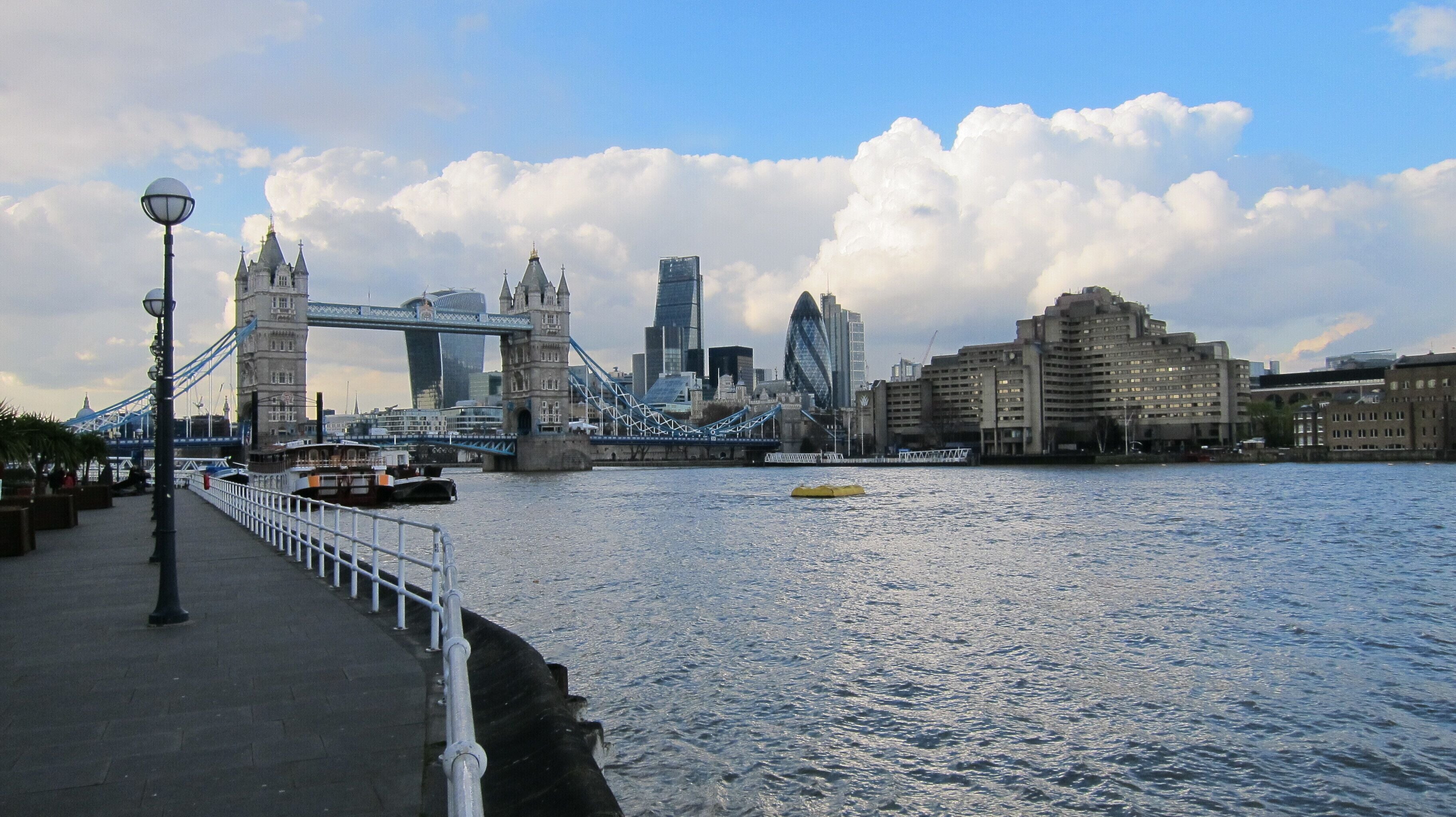 The Tower Bridge and modern buildings across the River Thames in London.