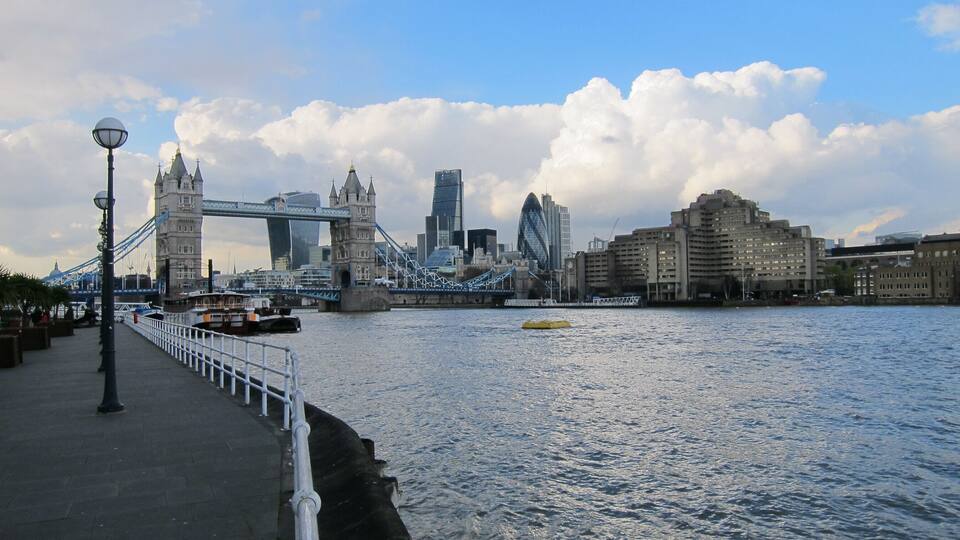 The Tower Bridge and modern buildings across the River Thames in London.