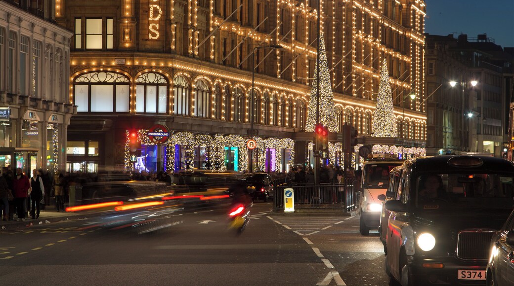 Harrods Department Store frontage as viewed along Brompton Rd at night.