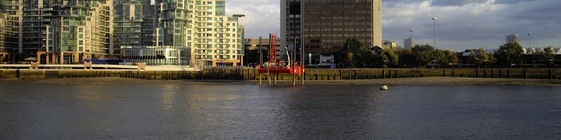 Drilling platform on the River Thames St George Wharf is on the left and Market Towers on the right