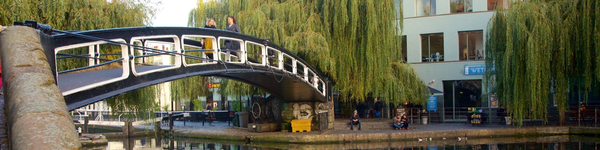 London which includes a bridge and a river or creek as well as a small group of people
