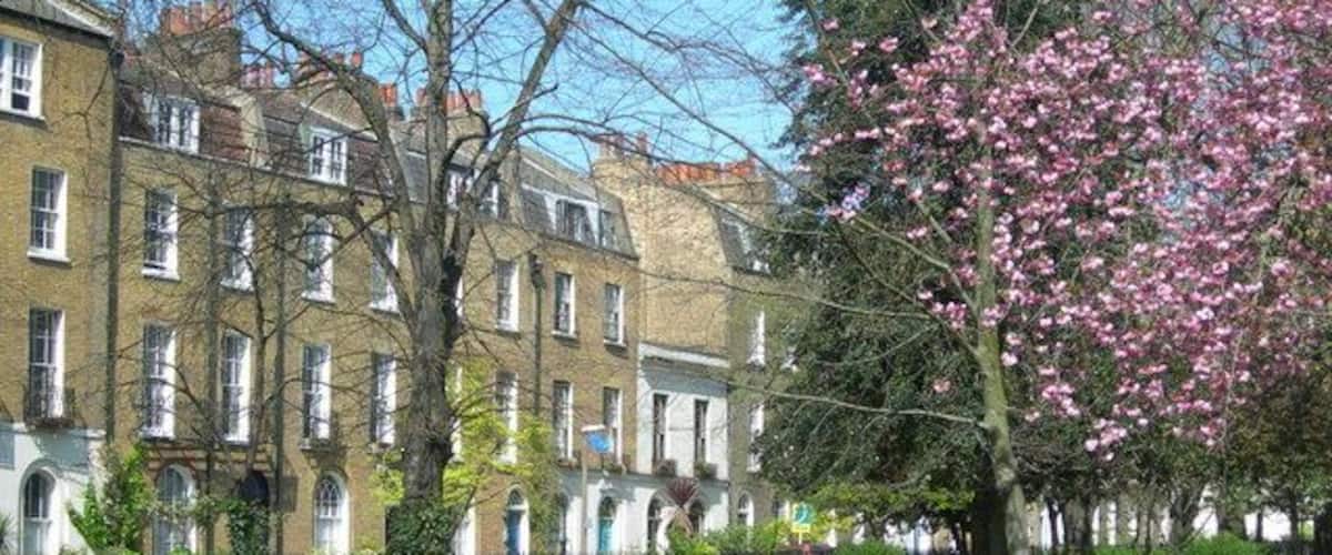 Clapton Square, Hackney, London. Showing the park and some houses on the road around it.