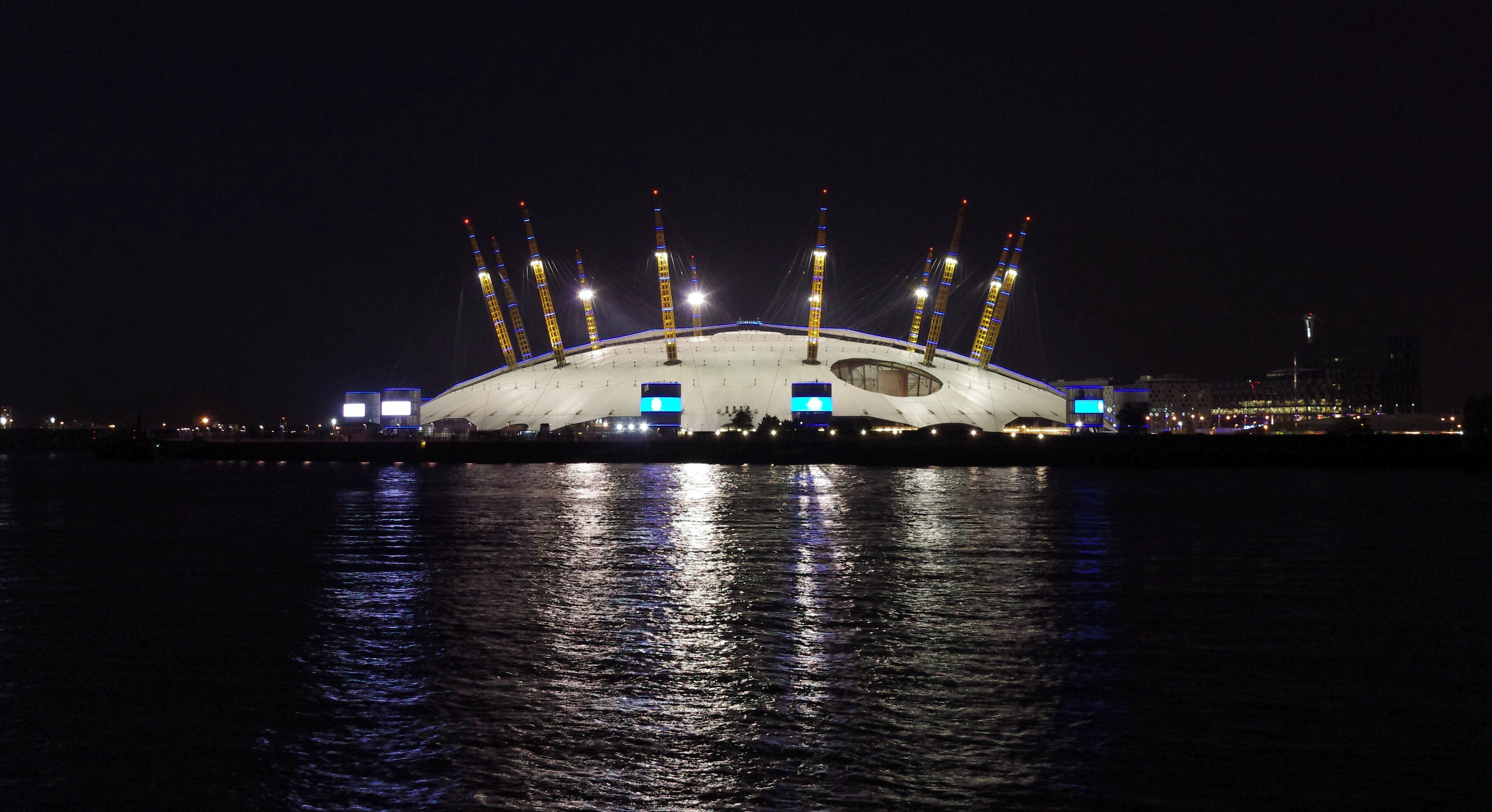 The Millennium Dome at night, seen from across the Thames.