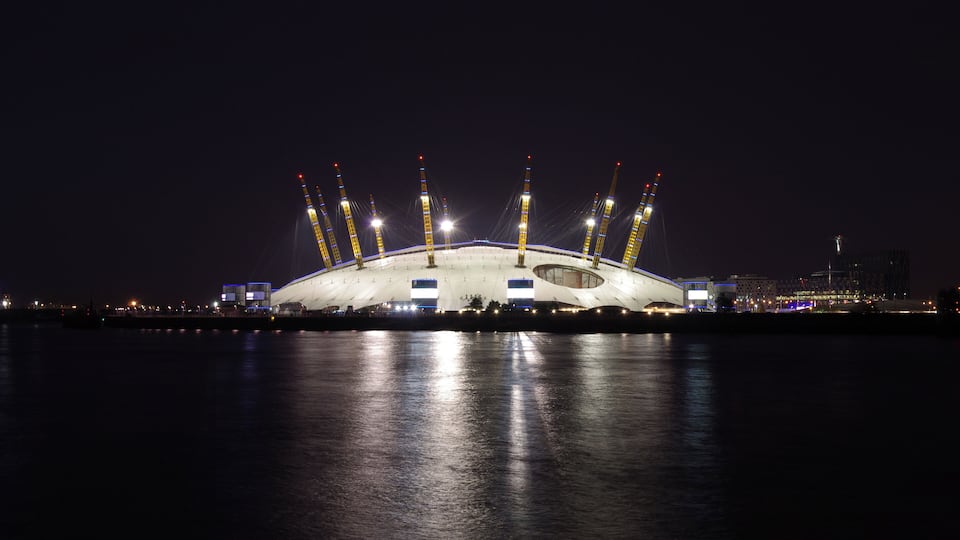The Millennium Dome at night, seen from across the Thames.