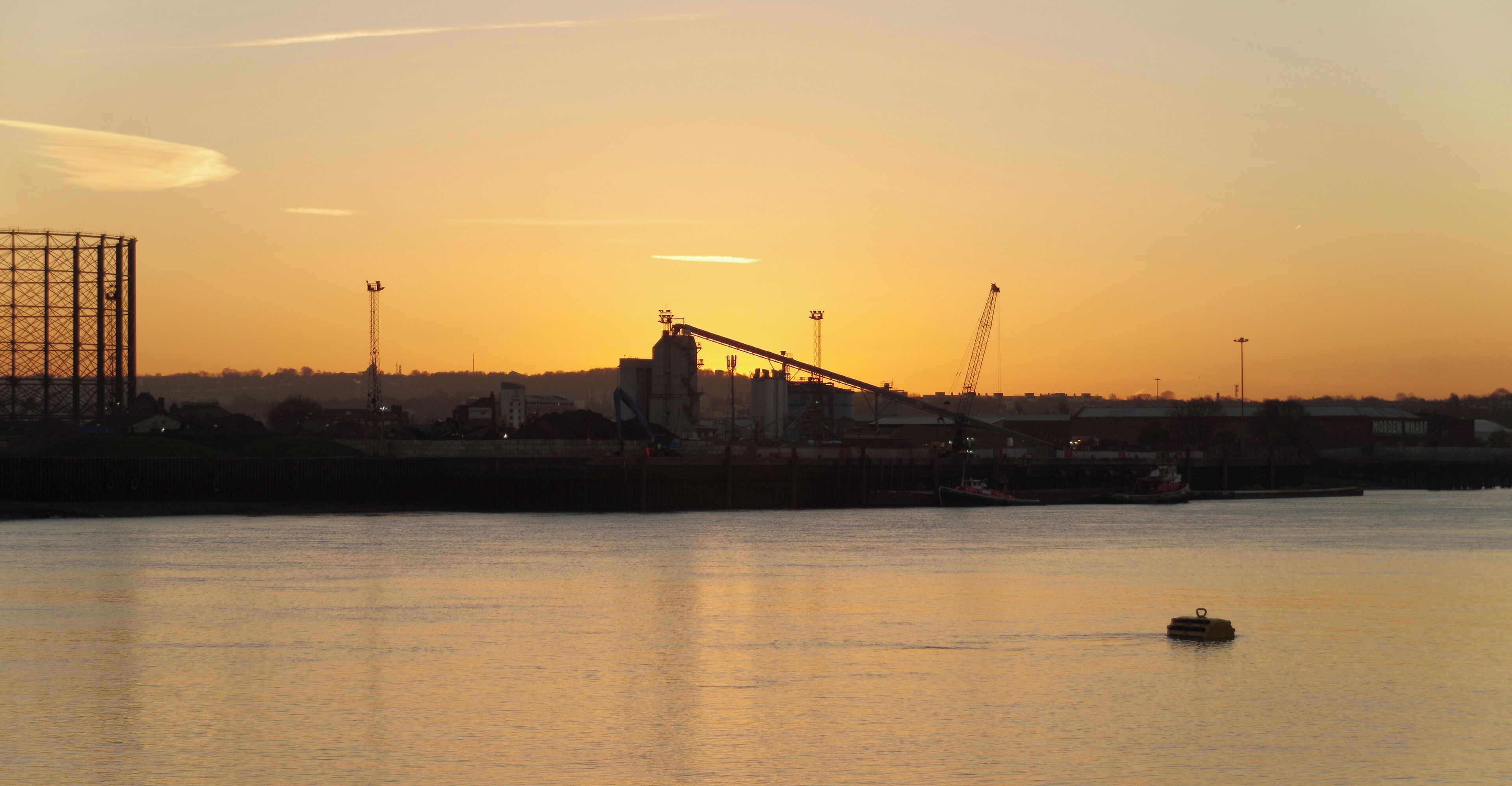 Looking across the River Thames as the sun rises on a clear December morning. This was taken from near the eastern end of the City Canal.