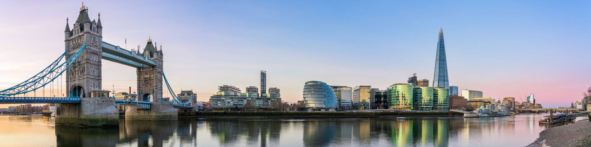 The Tower Bridge and modern buildings along the River Thames in London.