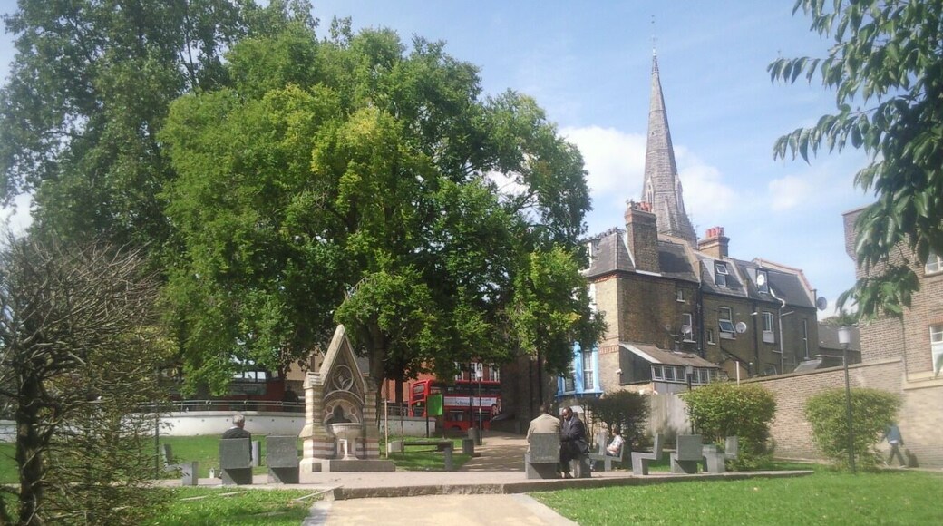 Part of Streatham Green, London SW16, looking north to the Dyce Drinking Fountain (left) and spire of the Roman Catholic church of the English Martyrs. The Dyce Fountain was moved here in 1933 from Streatham High Road.