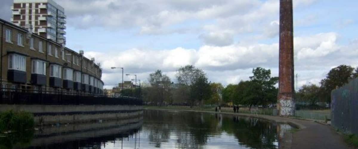 Regent's Canal approaching Mile End park The canal curves towards the west after Salmon Lane lock; the tall chimney seen here at the southern end of Mile End Park is an old sewer vent.