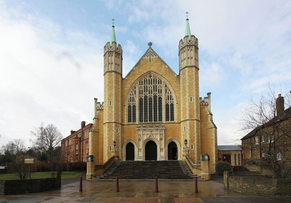 A large, historic church with twin spires and a large arched window.
