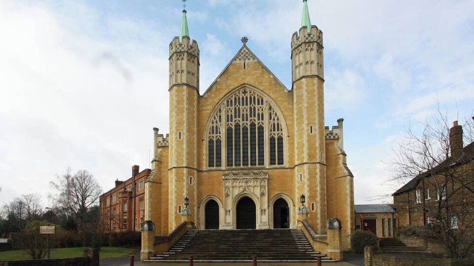 A large, historic church with twin spires and a large arched window.