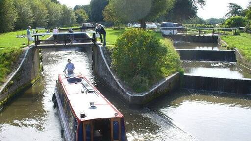 Papercourt Lock and Weir This is "The Lock That Moved". The lock-keeper's cottage is to the right, off camera. The narrowboat, "Bella", is heading downstream towards Newark Priory. See link for history on the old lock. http://www.weyriver.co.uk/theriver/wey_nav_3.htm