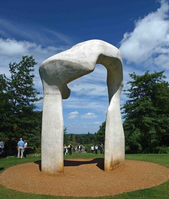 A large, abstract sculpture in a park.