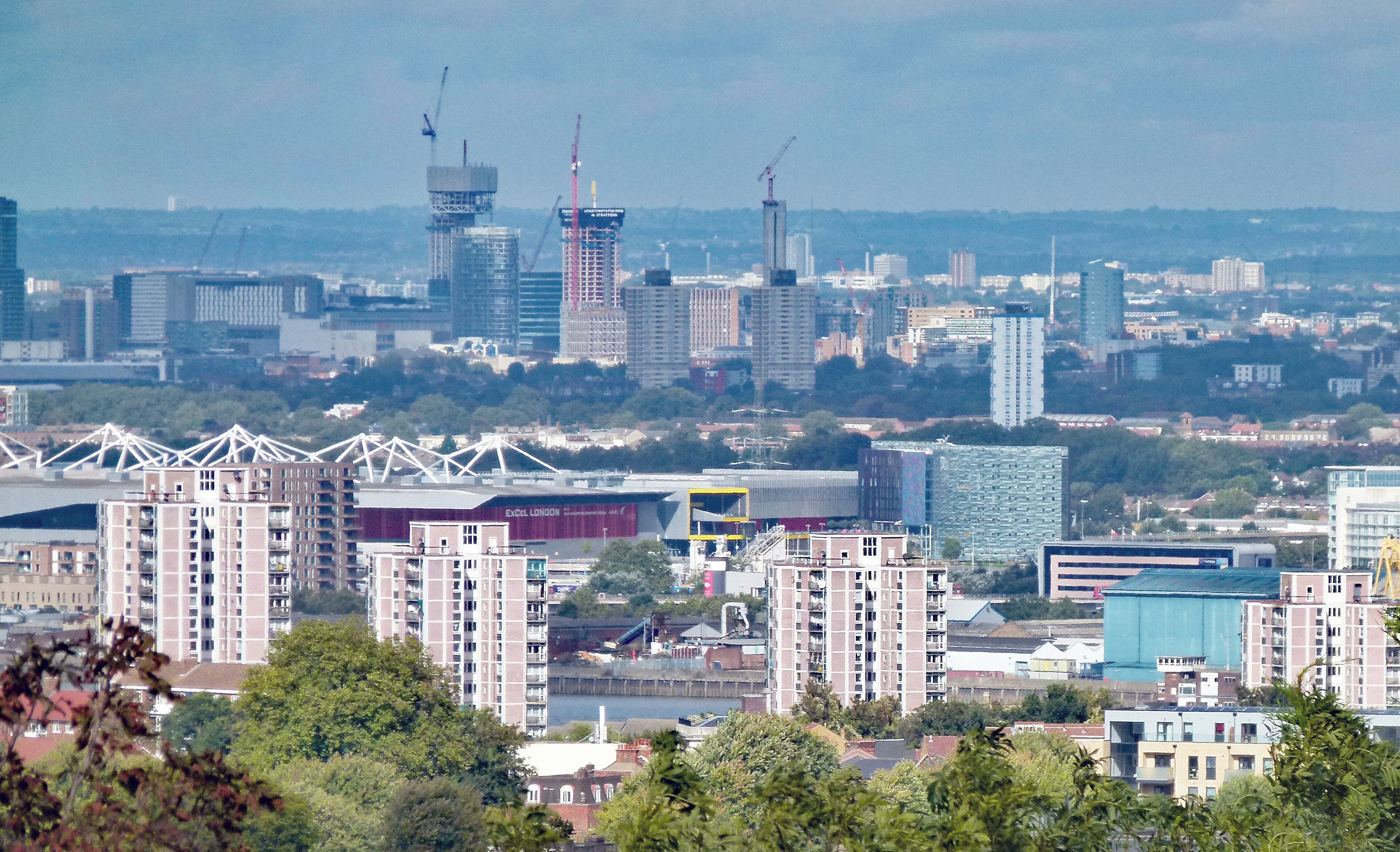 View towards the northwest from Eglinton Hill, Shooter's Hill, South east London, UK. The apartment blocks in the foreground are in Woolwich. In the centre is the ExCeL exhibition centre. In the background Stratford.