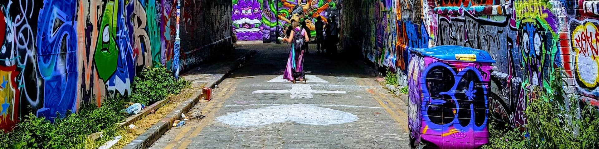 A tunnel with colorful graffiti on the walls.