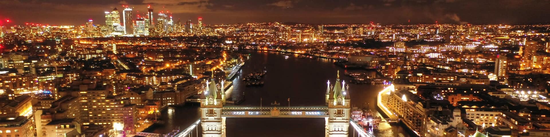 Aerial drone high resolution night photo of iconic Tower Bridge in the heart of City of London, United Kingdom