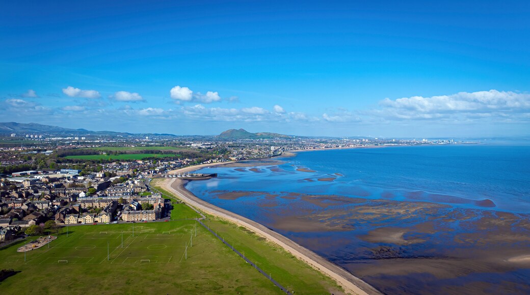 Aerial view of coastal village with ocean and mountains, Millhill, Musselburgh, Scotland.