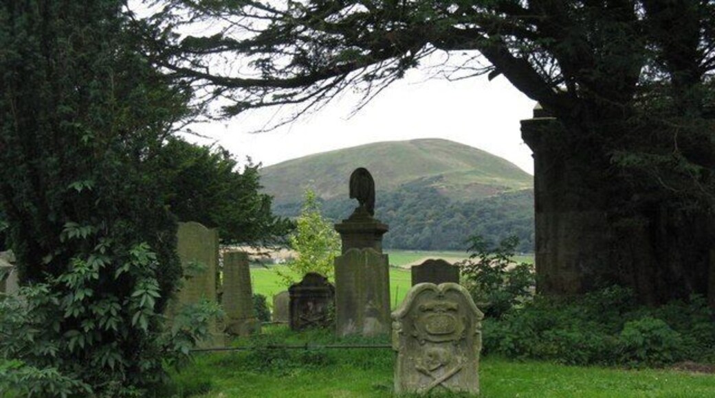 The view from the Old Pentland Kirkyard The Gibsone Mausoleum, dating from 1839, in silhouette to the right, a group of memorials, many of the Umpherston's and Aitchison's, mainly 17 & 18 Century but some at least from the start of the 20 Century, and the Pentland Hills in the distance.