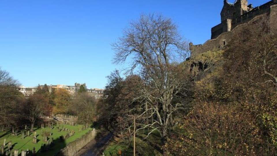 Entrance to Princes Street Gardens A view from Castle Terrace that takes in St. Cuthbert's cemetery, the entrance to Princes Street Gardens and Edinburgh Castle itself. The buildings of Princes Street can also be seen in the background.