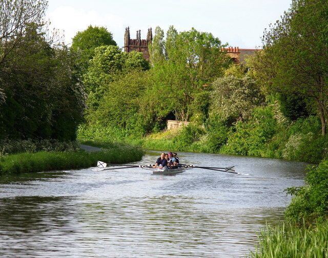 Union Canal, Merchiston In the early evening sun a boat from St Andrew Boat Club was out training on the canal. Polwarth Parish Church is also visible. This was originally a Free Church and is now Church of Scotland. The original design for the tower by Sidney Mitchell & Wilson included a spire but was later changed by James Jerdan & Son.