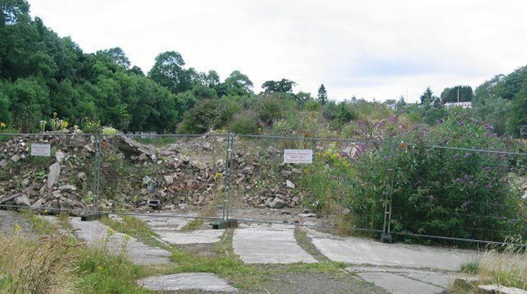Kinleith Mill. The entrance to the former mill complex beside the Water of Leith is tucked into the northwest corner of this Pentland square. Photo taken from the walkway a former railway line. Note the rails going into the site. Derelict for years it is planned to develop the site for housing.