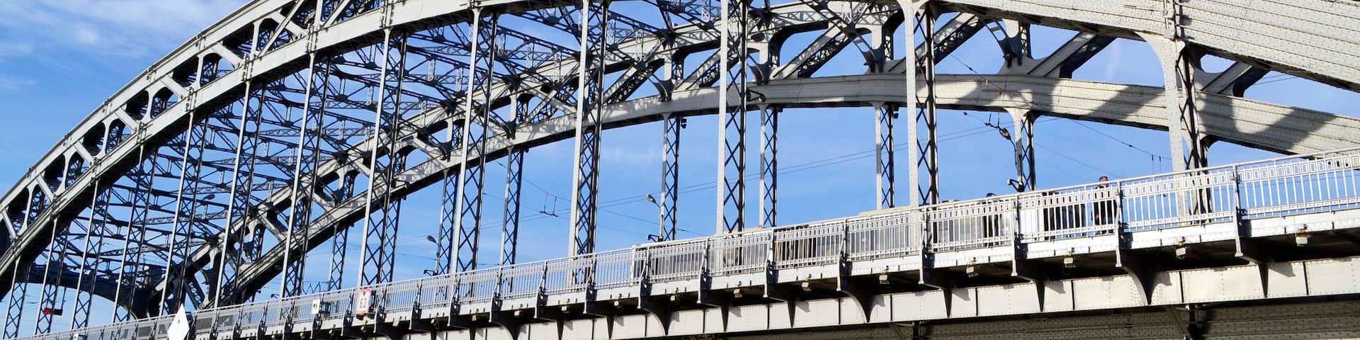A large steel bridge with a train crossing it.
