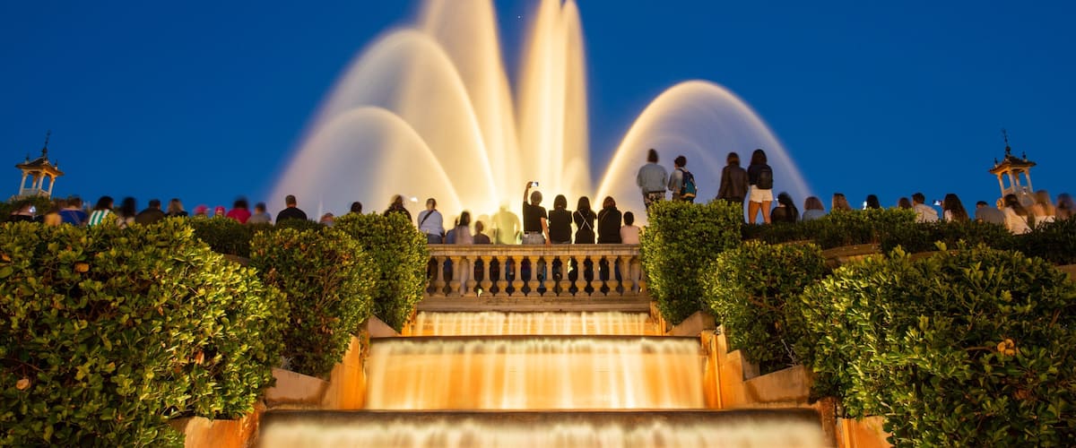 Sants-Montjuïc featuring night scenes and a fountain as well as a small group of people