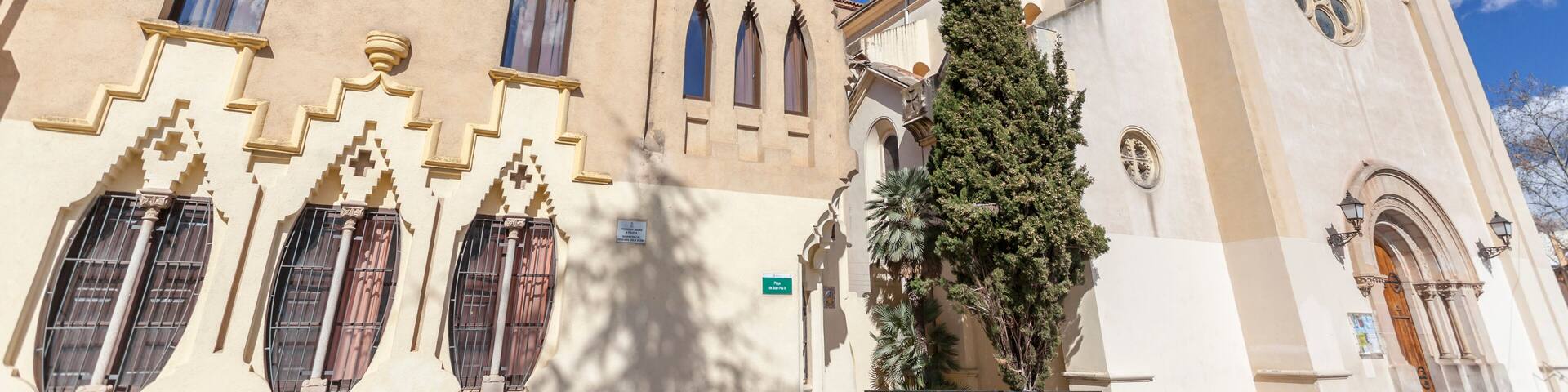 A historic building with arched windows and a bell tower.