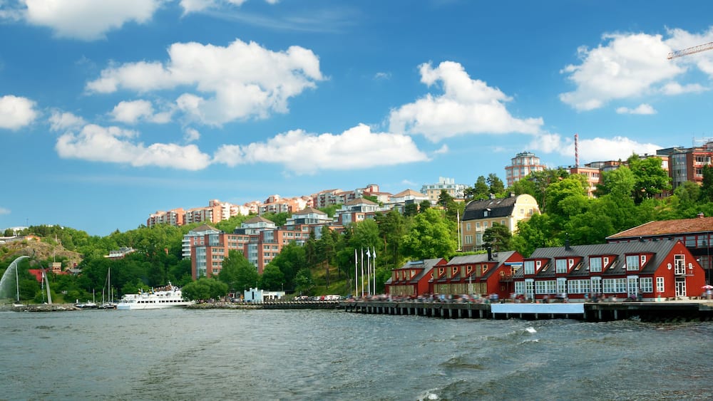 View to Stockholm, Sweden with a ferry from sea in summer. Nacka strand houses and harbour on sunny day