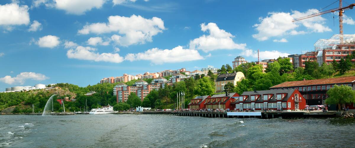 View to Stockholm, Sweden with a ferry from sea in summer. Nacka strand houses and harbour on sunny day